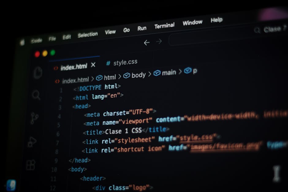 A close-up digital photograph displaying a computer screen with a code editor open, showing an HTML document. The code includes tags such as <html>, <head>, <title>, and <link>, with syntax highlighti